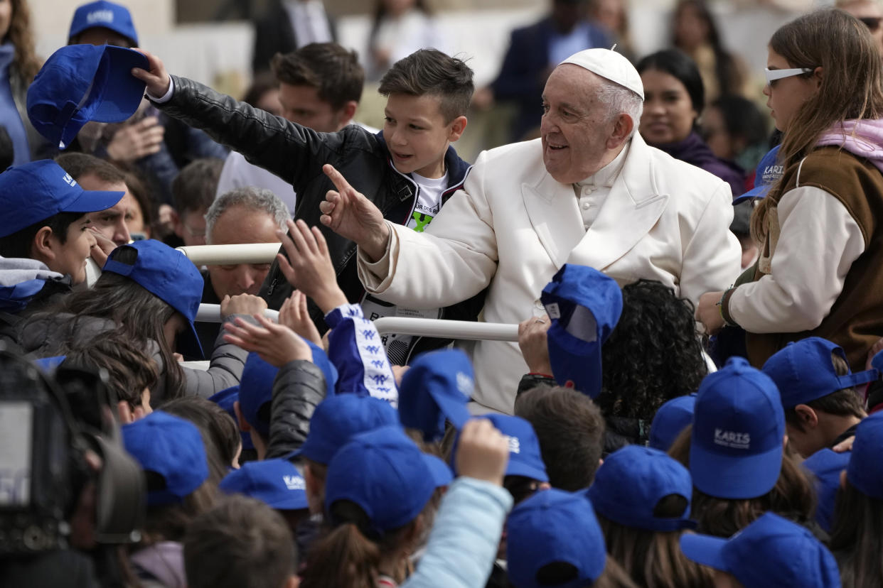 Pope Francis meets children at the end of his weekly general audience in St. Peter's Square, at the Vatican, Wednesday, March 29, 2023. (AP Photo/Alessandra Tarantino)