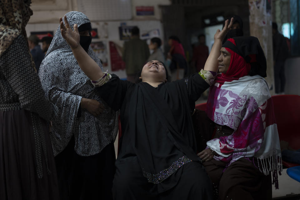 Rehana, center, wails inside a hospital following the death of her husband, Mohammad Zillur, in Munshiganj, outside Dhaka, Bangladesh, Sunday, Jan. 7, 2024. Zillur, a supporter of a candidate from the ruling Awami League was stabbed to death on Sunday as Bangladesh voted in a parliamentary election boycotted by the main opposition party. (AP Photo/Altaf Qadri)