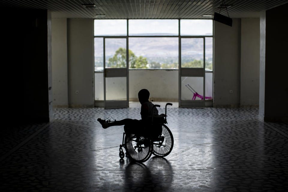 Patient Desalegn Gebreselassie, 15, uses a wheelchair to explore the Ayder Referral Hospital in Mekele, in the Tigray region of northern Ethiopia, on Thursday, May 6, 2021. His foot was injured when a grenade exploded in his town of Edaga Hamus. (AP Photo/Ben Curtis)