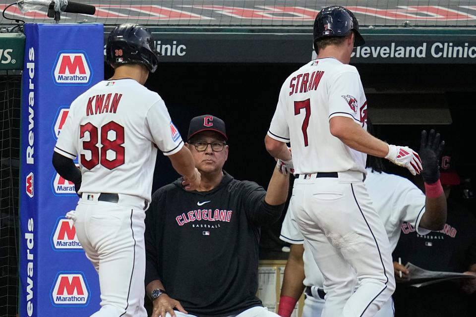 Steven Kwan (38) and Myles Straw (7) are greeted by Terry Francona after scoring against Atlanta, July 3, 2023.