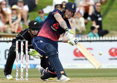 Cricket - ODI - New Zealand vs England - Seddon Park, Hamilton, New Zealand, February 25, 2018. England's Ben Stokes hits a shot as New Zealand's wicket-keeper Tom Latham watches during their one-day international match. REUTERS/Ross Setford