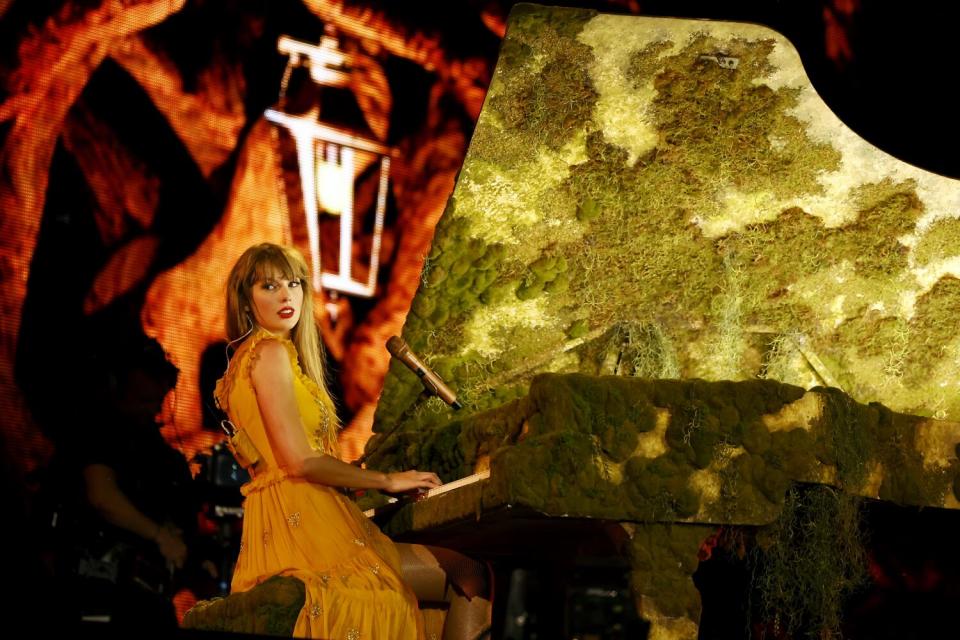 Taylor Swift plays her mossy piano.