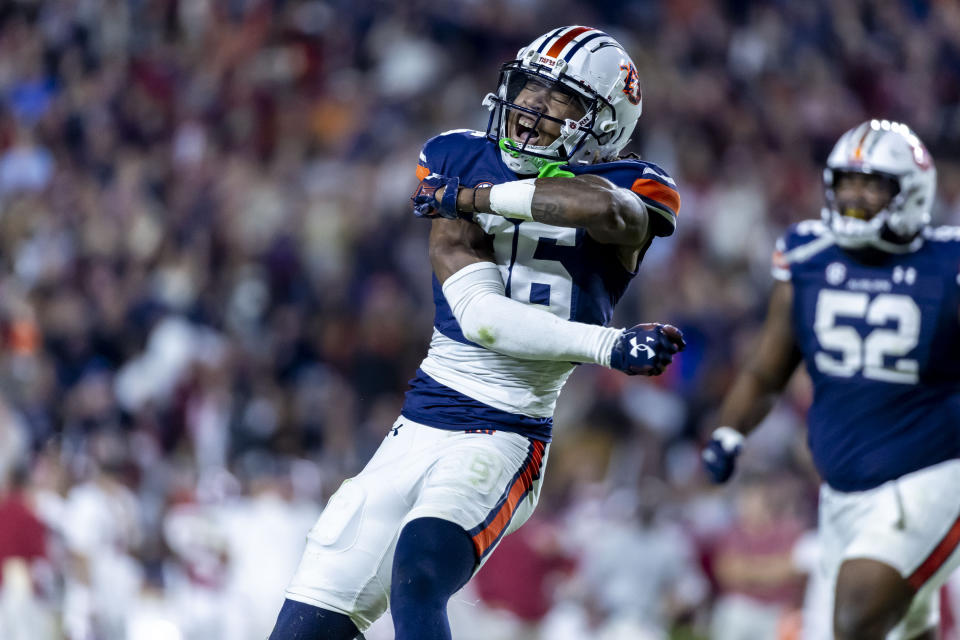 Auburn cornerback Jaylin Simpson (36) celebrates after Alabama missed a field goal during the second half of an NCAA college football game, Saturday, Nov. 25, 2023, in Auburn, Ala. (AP Photo/Vasha Hunt)