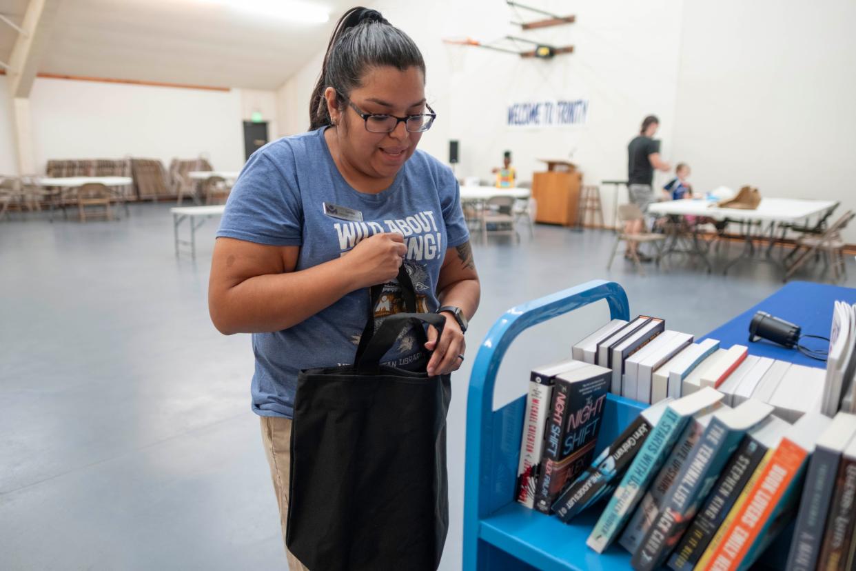 Serina Freeman with the Almonte Library works in the temporary library space within Trinity Lutheran Church in Oklahoma City.