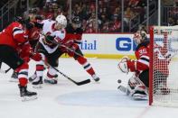 Feb 21, 2019; Newark, NJ, USA; New Jersey Devils goaltender Cory Schneider (35) makes a save while Ottawa Senators left wing Rudolfs Balcers (38) and New Jersey Devils right wing Drew Stafford (18) battle for the rebound during the third period at Prudential Center. Mandatory Credit: Ed Mulholland-USA TODAY Sports