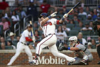 Atlanta Braves' Austin Riley follows through on an RBI single during the third inning of the team's baseball game against the New York Mets, Thursday, Aug. 18, 2022, in Atlanta. (AP Photo/Brett Davis)