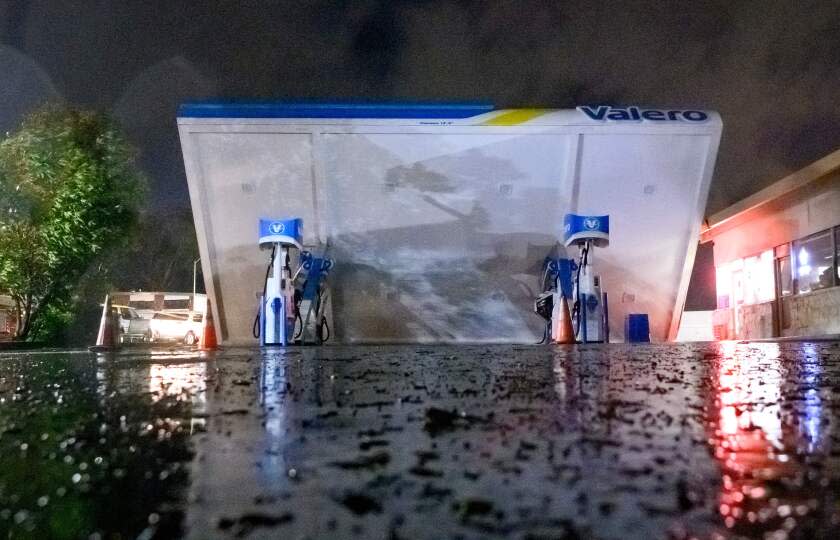 A damaged Valero gas station creaks in the wind during a massive "bomb cyclone" rain storm in South San Francisco, California on January 4, 2023. - A bomb cyclone smashed into California on January 4, 2023, bringing powerful winds and torrential rain that was expected to cause flooding in areas already saturated by consecutive storms. (Photo by JOSH EDELSON / AFP) (Photo by JOSH EDELSON/AFP via Getty Images)