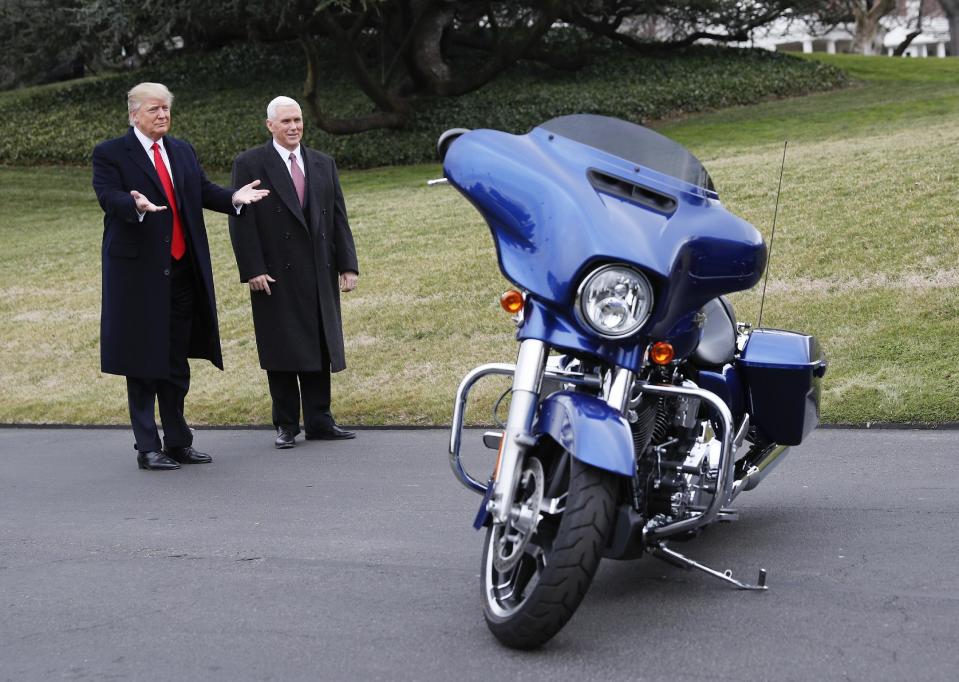 President Donald Trump and Vice President Mike Pence stop to admire a Harley Davidson motorcycle parked on the South Lawn of the White House in Washington, Thursday, Feb. 2, 2017. (AP Photo/Pablo Martinez Monsivais)