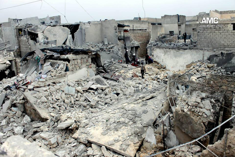 In this picture taken on on Thursday, Jan. 23, 2014, a citizen journalism image provided by Aleppo Media Center (AMC), an anti-Bashar Assad activist group which has been authenticated based on its contents and other AP reporting, Syrian residents and rescue workers check the rubble of houses damaged, according to AMC, attacked by the Syrian forces airplanes in Aleppo, Syria. AMC said the attack was by the Syrian forces airplanes. Direct talks planned between President Bashar Assad's government and the Western-backed opposition hoping to overthrow him were scrapped Friday, and the two sides will meet a U.N. mediator in different rooms at different times. (AP Photo/Aleppo Media Center, AMC)