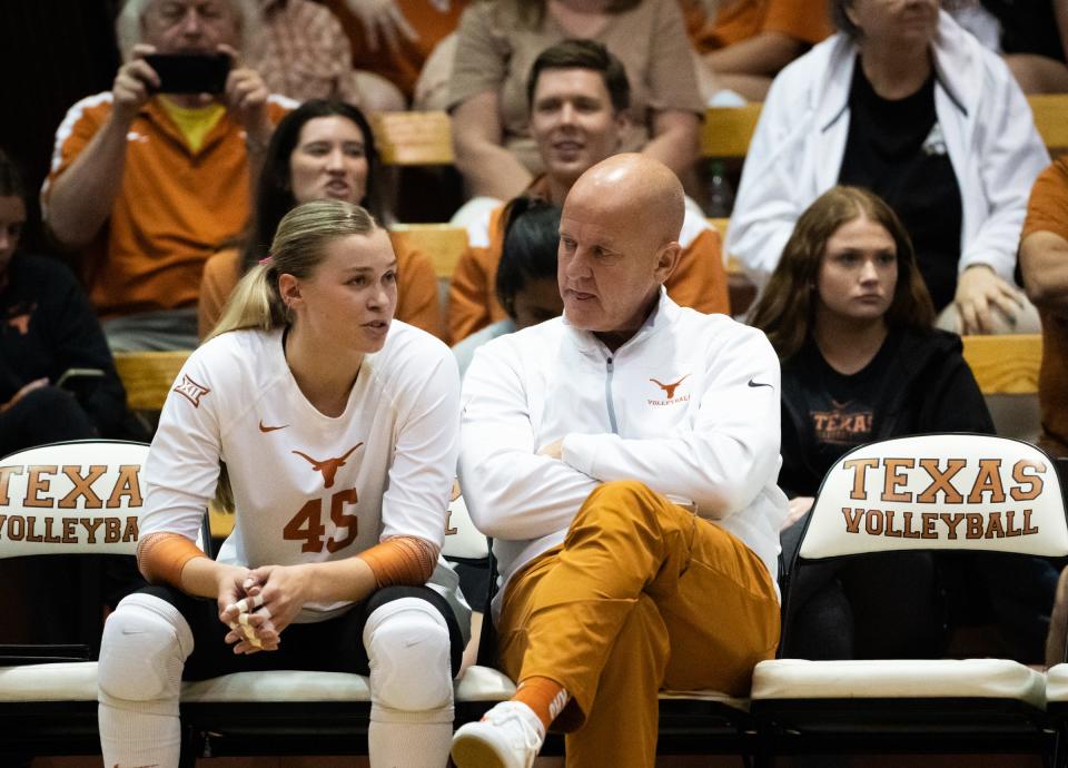 Texas outside hitter Jenna Wenaas speaks with coach Jerritt Elliott during the Longhorns' spring game against Baylor at Gregory Gym in April. Elliott says he would like for Texas to play a volleyball match in Moody Center.