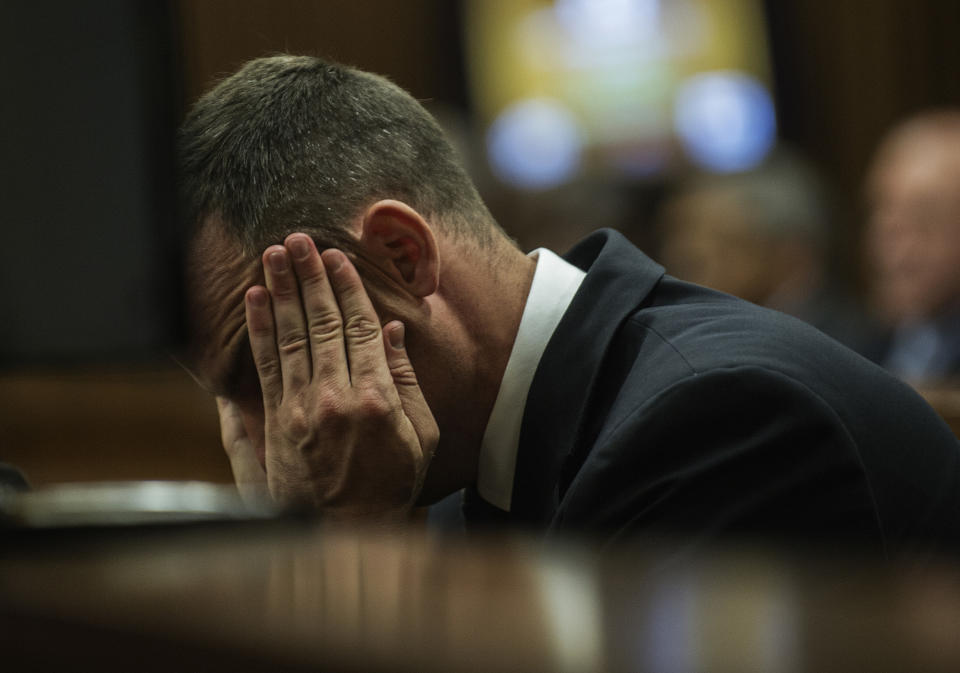 Oscar Pistorius cradles his head in his hands as he listens to evidence during his murder trial in Pretoria, South Africa, Thursday, May 8, 2014. Pistorius is charged with the shooting death of his girlfriend Reeva Steenkamp on Valentine's Day in 2013. (AP Photo/Gianluigi Guercia, Pool)