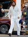 <p>Bradley Cooper wears an all-white '70s look, long hair and a beard while on set for an untitled Paul Thomas Anderson project in L.A. on Monday. </p>
