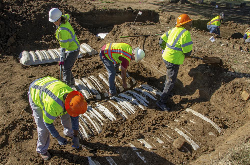 In this image provided by the City of Tulsa, Crews work on an excavation at Oaklawn Cemetery searching for victims of the 1921 Tulsa Race Massacre on Thursday, Oct. 27, 2022, in Tulsa, Okla. Officials say the search for remains of victims of the 1921 Tulsa Race Massacre has turned up 21 additional graves in the city’s Oaklawn Cemetery. (City of Tulsa via AP)