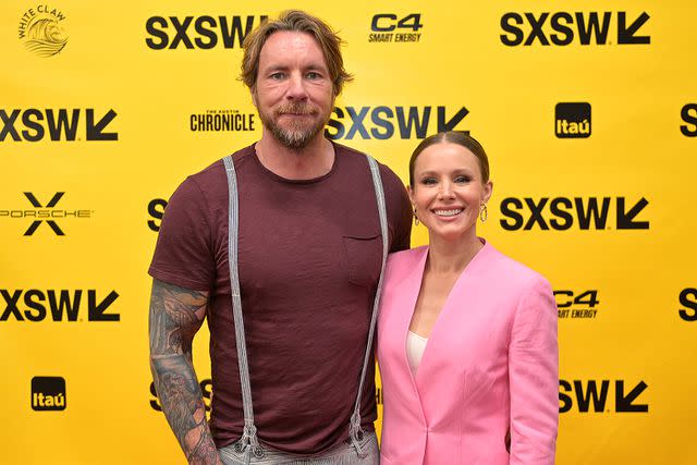 <p>Jason Bollenbacher/Getty </p> Dax Shepard poses with Kristen Bell at the Austin Convention Center in March 2023