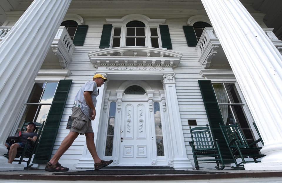 Chuck Capehart walks across the front porch of the Bellamy Mansion while touring the historic home in Wilmington, N.C.    [STARNEWS FILE PHOTO] 