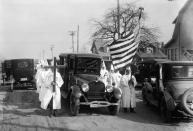 <p>Robed Ku Klux Klansmen accompanying the hearse of one of their members. Undated photograph in Freeport, N.Y. (Photo: Getty Images </p>