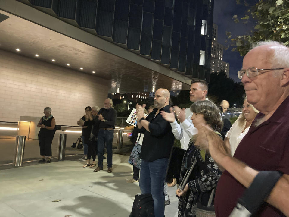 Family members applaud and cheer as U.S. Attorney Martin Estrada and prosectors walk out of the courthouse after a verdict at federal court in Los Angeles, Monday, Nov.6, 2023. A federal jury found that scuba dive boat captain Jerry Boylan was criminally negligent in the deaths of 34 people killed in a fire aboard the vessel in 2019, the deadliest maritime disaster in recent U.S. history. (AP Photo/Stefanie Dazio)