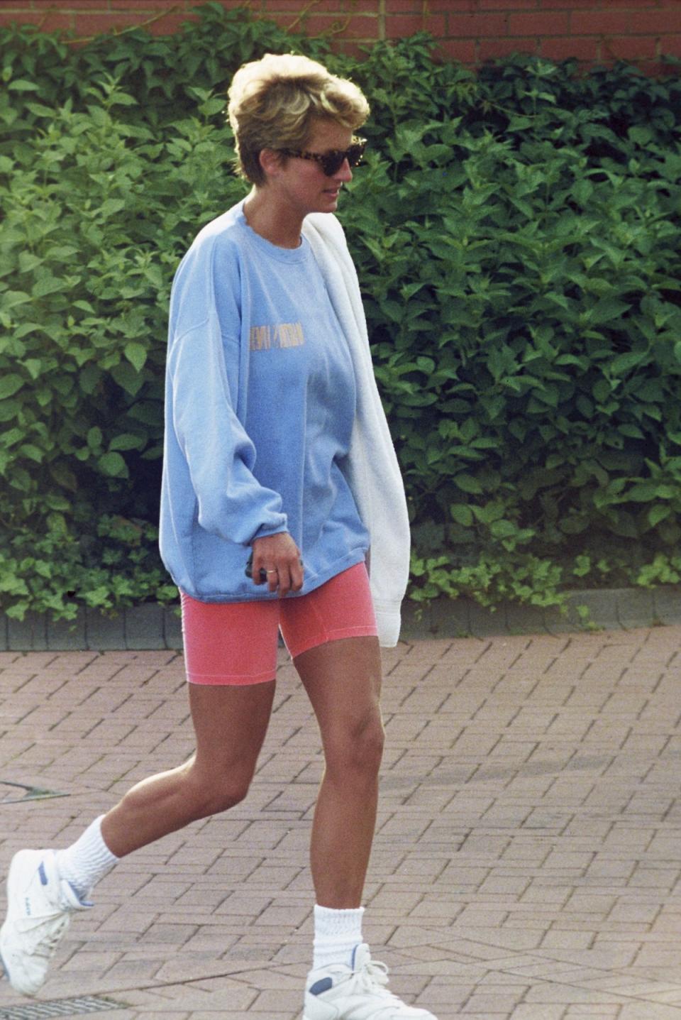 <p>The Princess of Wales was notoriously fit, and that obviously comes from hard work at the gym. She was never shy — particularly after her separation — about wearing sweatshirts and shorts in public after a workout. (Photo: Anwar Hussein/Getty Images) </p>