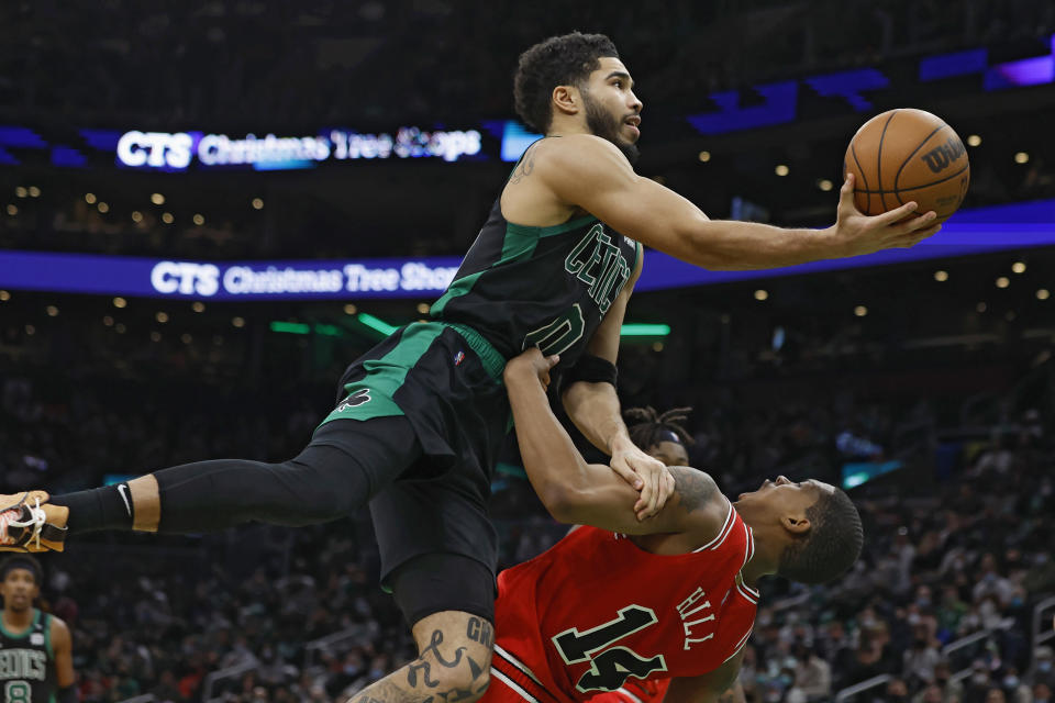 Boston Celtics' Jayson Tatum (0) shoots over Chicago Bulls' Javonte Green (24) during the second half of an NBA basketball game, Saturday, Jan. 15, 2022, in Boston. (AP Photo/Michael Dwyer)