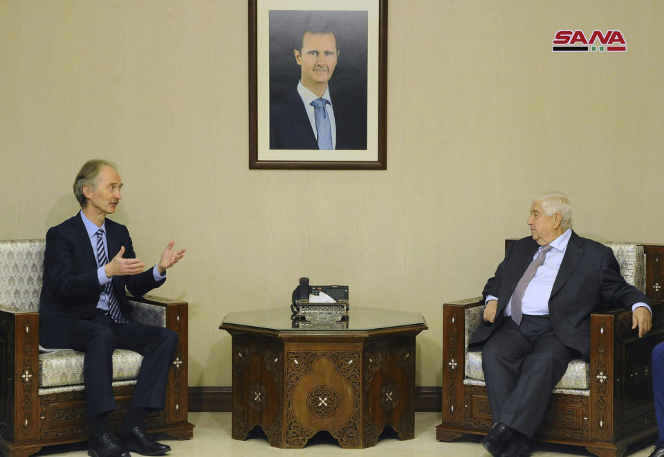 In this photo released by the Syrian official news agency SANA, Syria's Foreign Minister Walid al-Moallem, right, meets with the United Nations’ new special envoy for Syria, Geir Pedersen, in Damascus, Syria, Tuesday, Jan. 15, 2019. Turkey's President Recep Tayyip Erdogan said Tuesday that his troops will establish a 20-mile-wide "safe zone" in northern Syria, adding that Turkey would seek logistic and financial assistance from the United States and other allies to create the zone. (SANA via AP)