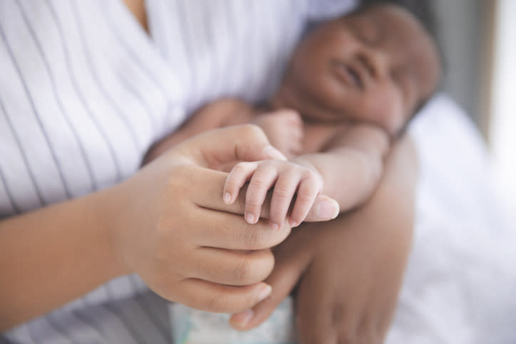 A woman holding a baby