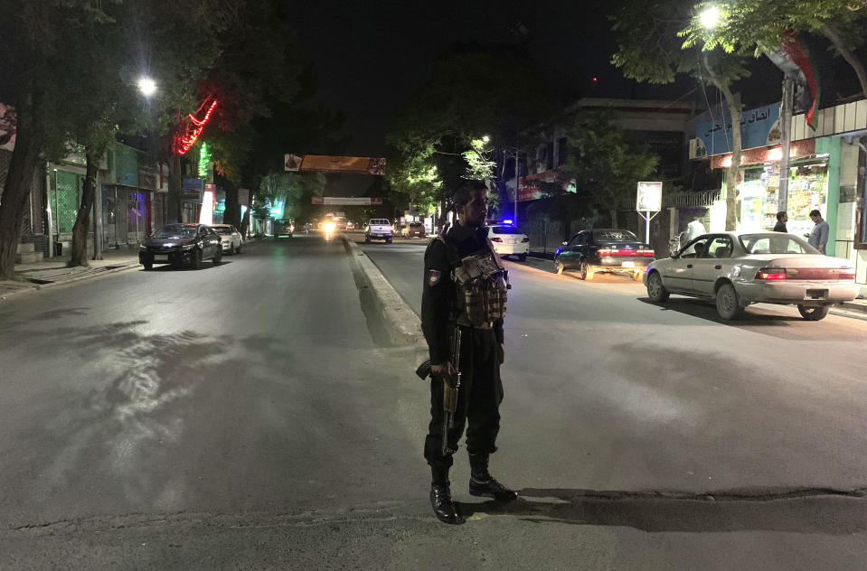 An Afghan policeman stands guard at the site of a bombing in a mosque in Kabul, Afghanistan, Tuesday, June 2, 2020. Tariq Arian, spokesman for the Afghan interior ministry says the the attack has taken place inside the compound of Wazir Akber Khan Mosque on the Tuesday evening. (AP Photo/Rahmat Gul)