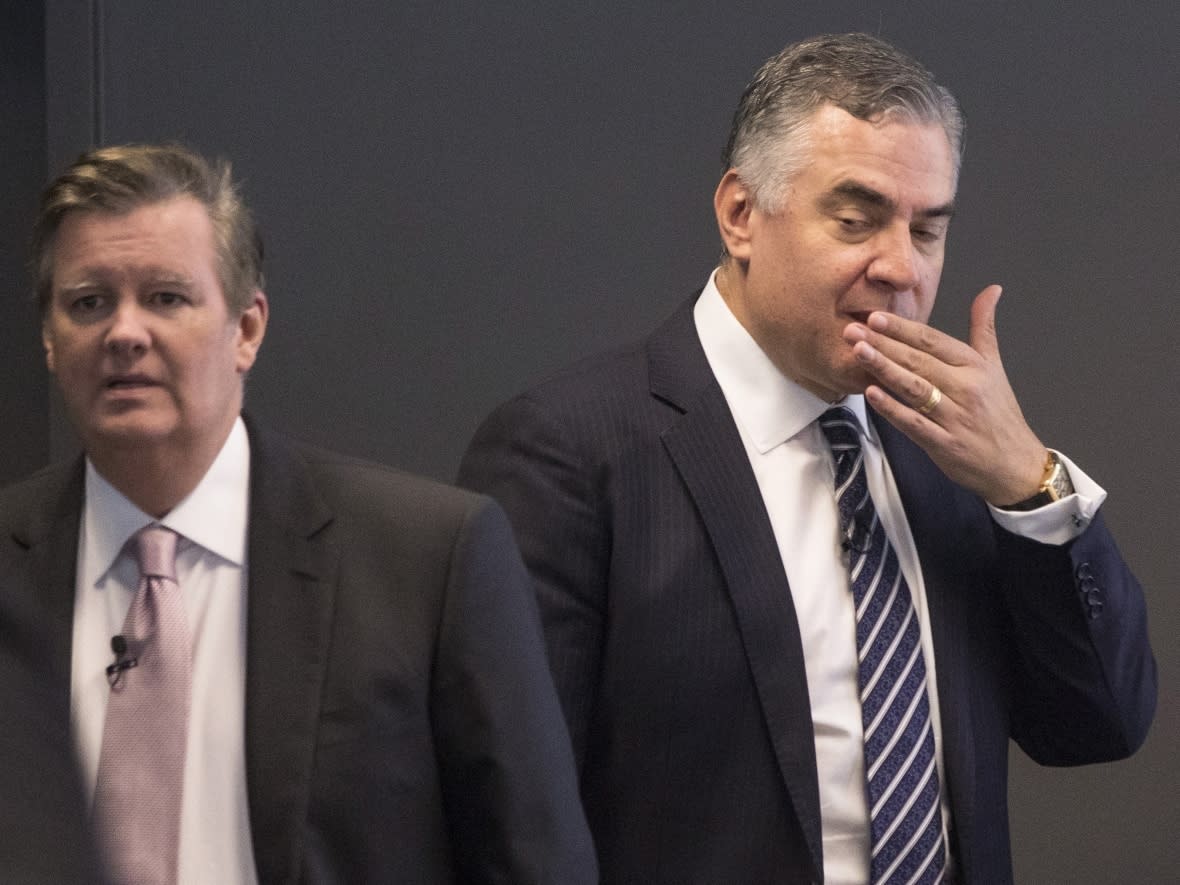 Rogers president and CEO Joe Natale, right, and chair of the board Edward Rogers are shown at the company's annual general meeting in 2019. (Chris Young/The Canadian Press - image credit)