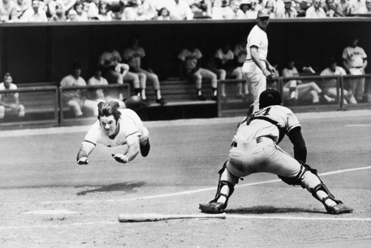 Cincinnati, Ohio- Pete Rose of the Reds dives into home plate past the glove of Giants' catcher Dave Rader, July 30th, in first game of double-header.