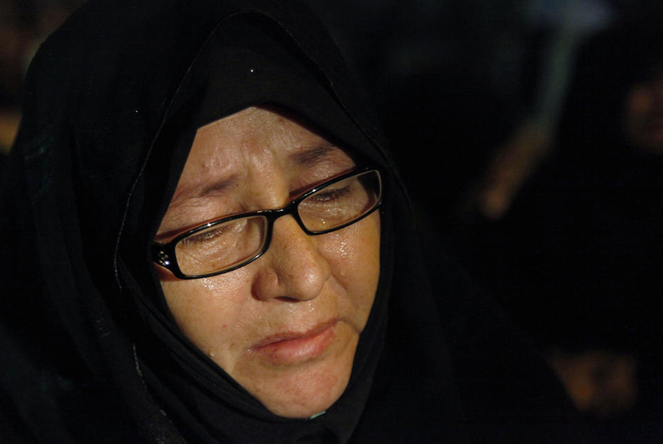 A Pakistani woman cries during a rally to condemn Tuesday's killings of Shiite Muslims, in Karachi, Pakistan, Wednesday, Jan. 22, 2014. A roadside car bomb hit a bus of Shiite pilgrims returning from Iran, killing several people and wounding many, in restive Baluchistan province, said a top security official. (AP Photo/Shakil Adil)