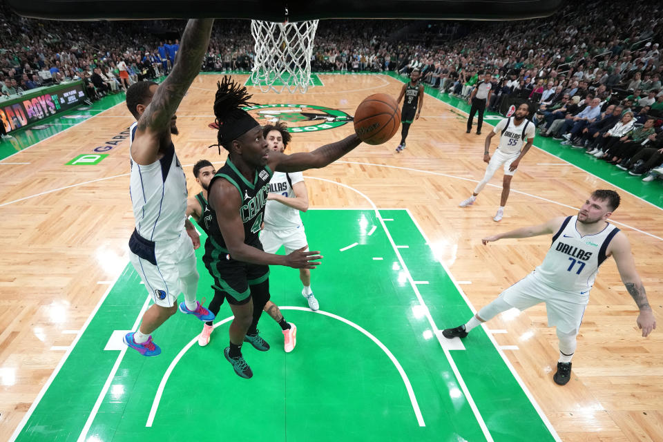BOSTON, MASSACHUSETTS - JUNE 09: Jrue Holiday #4 of the Boston Celtics shoots the ball against PJ Washington #25 of the Dallas Mavericks during the second quarter of game two of the 2024 NBA Finals at TD Garden on June 09, 2024 in Boston , Massachusetts.  NOTE TO USER: User expressly acknowledges and agrees that by downloading and/or using this photograph, User is agreeing to the terms and conditions of the Getty Images License Agreement.  (Photo by Peter Casey - Piscina/Getty Images)
