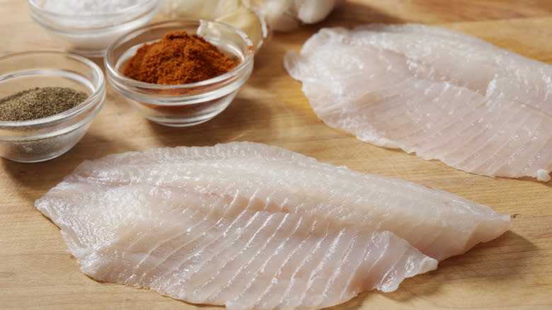 tilapia filets on cutting board