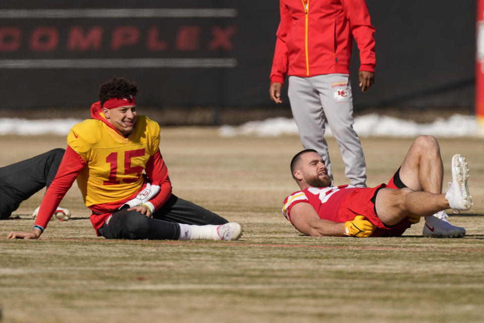 Kansas City Chiefs quarterback Patrick Mahomes (15) and Kansas City Chiefs tight end Travis Kelce stretch during an NFL football workout Thursday, Feb. 2, 2023, in Kansas City, Mo. The Chiefs are scheduled to play the Philadelphia Eagles in Super Bowl LVII on Sunday, Feb. 12, 2023. (AP Photo/Charlie Riedel)