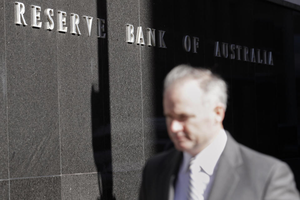 FILE - In this Oct. 1, 2019, file photo, a man walks past the Reserve Bank of Australia in Sydney. Australia’s central bank on Tuesday, March 3, 2020 cut its benchmark interest rate by a quarter of a percentage point to a record low of 0.5% in response to the economic shock of the new coronavirus. (AP Photo/Rick Rycroft, File)