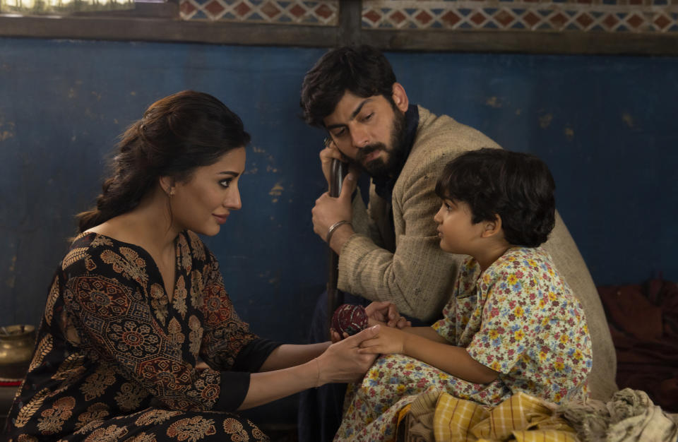 (L-R): Mehwish Hayat as Aisha, Fawad Kahn as Hasan, and Zion Usman as Young Sana in “Ms. Marvel.” - Credit: Patrick Brown / Marvel Studios