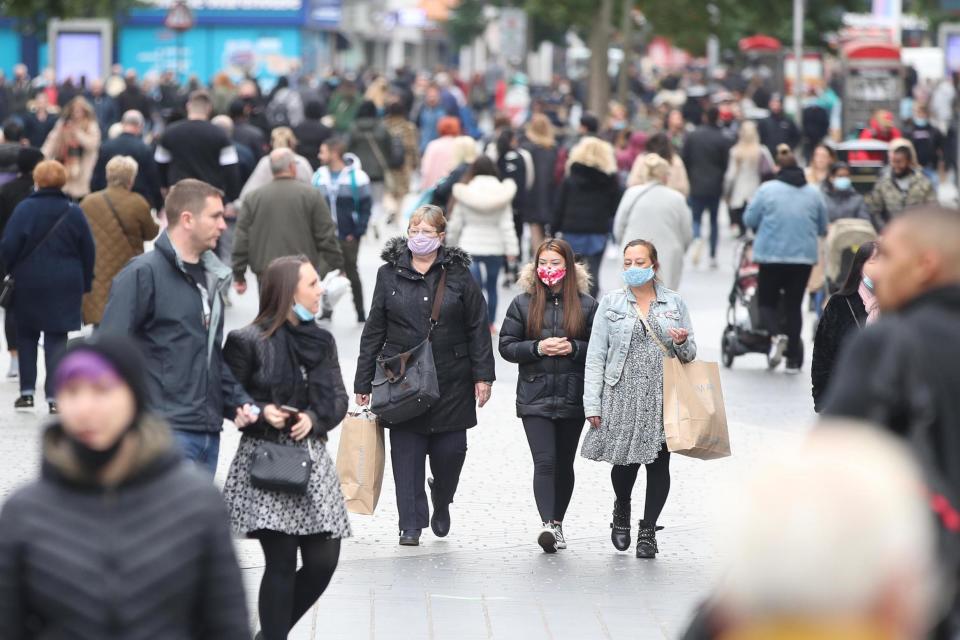 People wear face masks as they walk in Liverpool. The leaders of Leeds, Manchester and Newcastle city councils wrote to the Health Secretary with concerns about a rise in cases: PA