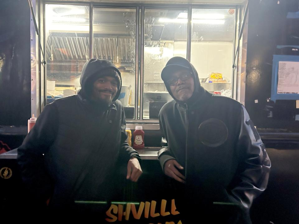 Demetrius Major, 35, of Detroit, left, stands with his father, Dwayne Major, 57, of Southfield, outside Tin Roof Detroit where Demetrius served customers in line from the bar’s food truck and his father works as the bar’s chef. They said the bar was packed for the Lions' playoff game on Sunday, Jan. 14, 2024. (Credit: Clara Hendrickson, Detroit Free Press)