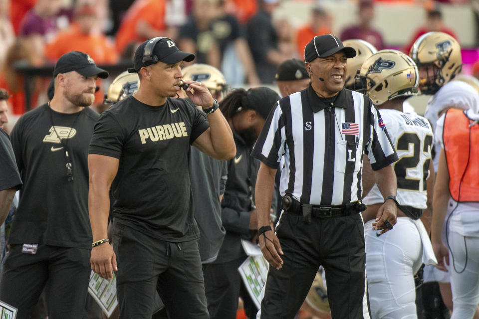 Purdue head coach Ryan Walters, second from left, watches from the sidelines during an NCAA college football game against Virginia Tech, Saturday, Sept. 9, 2023, in Blacksburg, Va. (AP Photo/Robert Simmons)