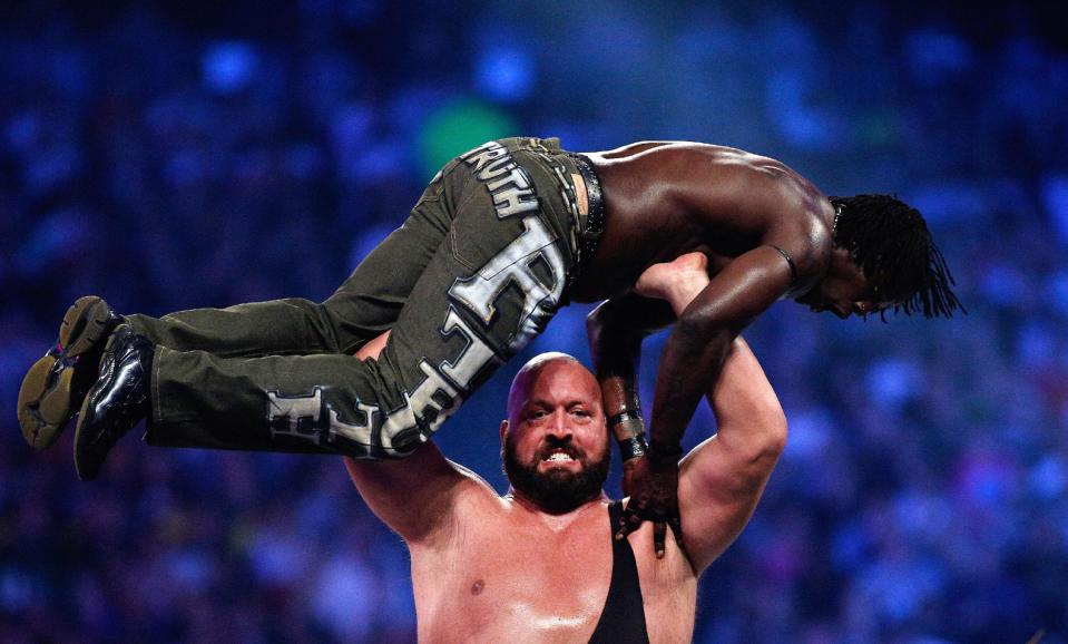 The Big Show holds R-Truth above his head during Wrestlemania XXX at the Mercedes-Benz Super Dome in New Orleans on Sunday, April 6, 2014. (Jonathan Bachman/AP Images for WWE)