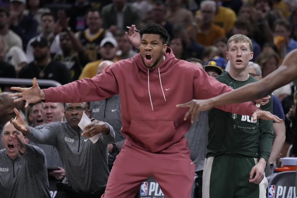 Milwaukee Bucks' Giannis Antetokounmpo, center front, reacts during the first half of Game 4 of an NBA basketball first-round playoff series against the Indiana Pacers, Sunday, April 28, 2024, in Indianapolis. (AP Photo/Michael Conroy)