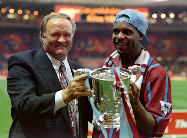 Former Aston Villa manager Ron Atkinson holds the League Cup with Dalian Atkinson