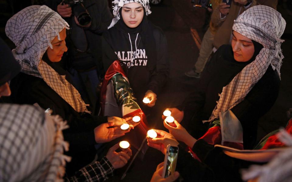 Pro-Palestine supporters light candles as they gather to show their solidarity with the people in Gaza in Palestine square in Tehran, Iran