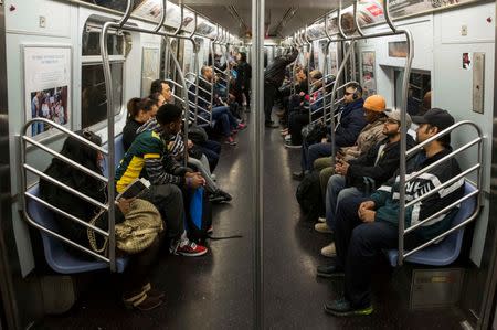 Commuters ride an L train for the morning commute in New York, U.S. on October 24, 2014. REUTERS/Lucas Jackson/File Photo