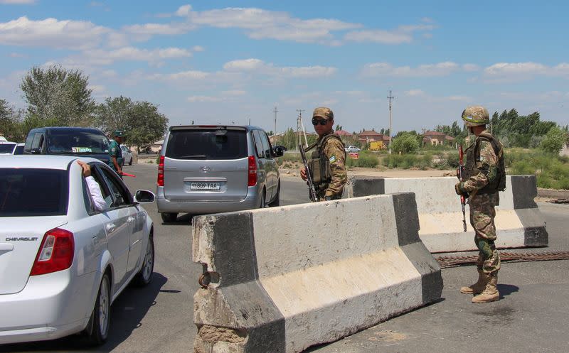 Uzbek service members guard a road in Nukus, capital of the northwestern Karakalpakstan region