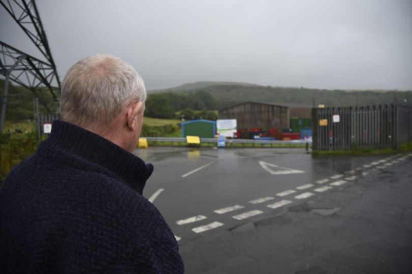 David, pictured looking inside the recycling centre near Aberdare, said he was stunned when he received the letter threatening legal action - Image credit: Jonathon Hill/Media Wales