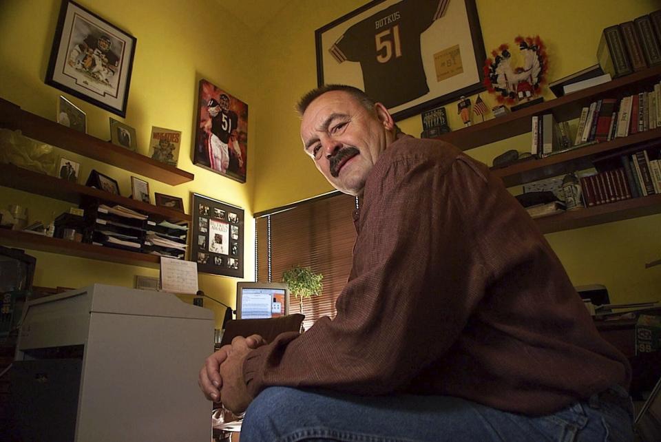 FILE - Former Chicago Bears linebacker Dick Butkus is surrounded by football memorabilia at his home in Malibu, Calif., Jan. 6, 2000. Butkus, a fearsome middle linebacker for the team has died, the Bears announced Thursday, Oct. 5, 2023. He was 80. According to a statement released by the team, Butkus' family confirmed that he died in his sleep overnight at his home in Malibu. (AP Photo/Mark J. Terrill)