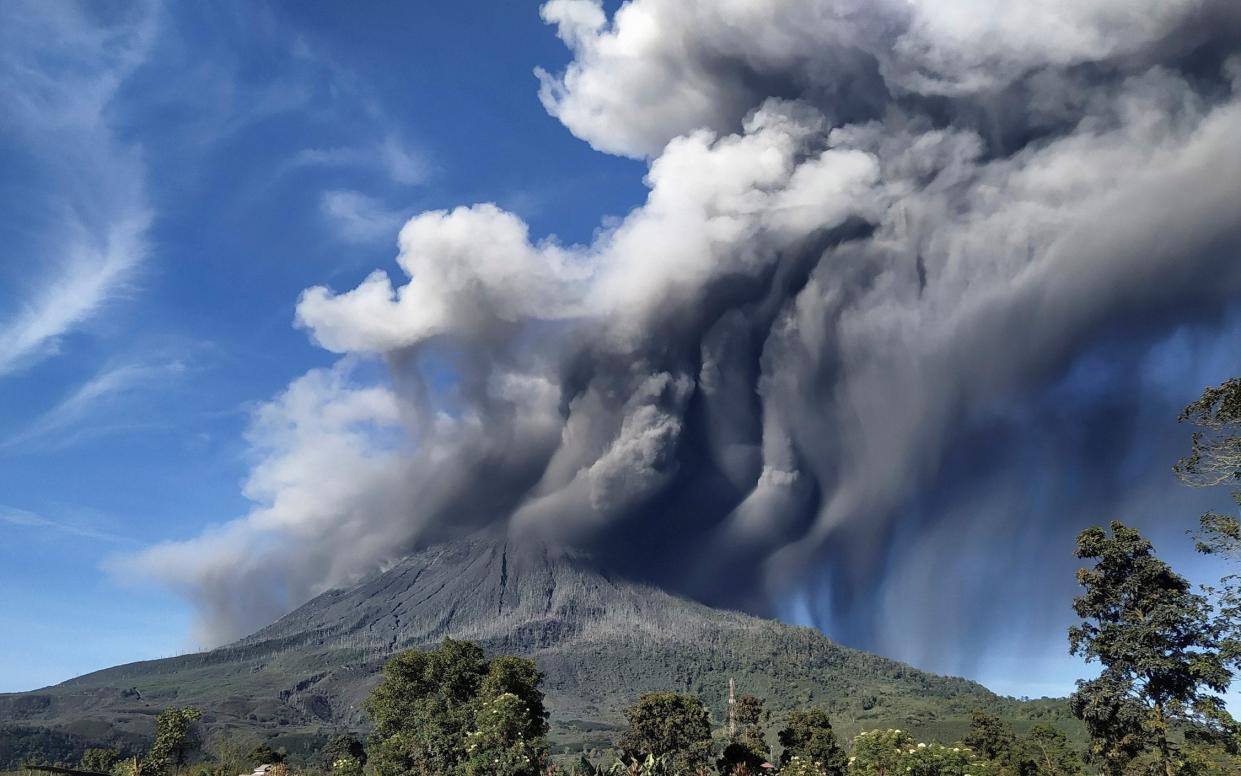 Mount Sinabung spews volcanic materials during an eruption, in Karo, North Sumatra, Indonesia