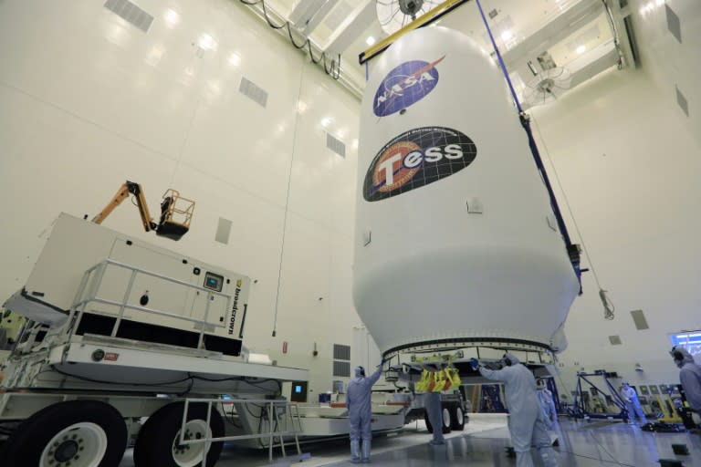 The SpaceX payload fairing containing the NASA’s Transiting Exoplanet Survey Satellite (TESS) is moved by crane to a transporter as it is readied for launch
