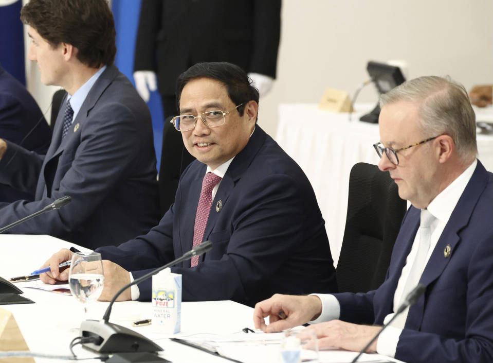 Vietnamese Prime Minister Phạm Minh Chinh, center, and Australian Prime Minister Anthony Albanese, right, attend an outreach session of the leaders of the G7 nations and invited countries, during the G7 Summit in Hiroshima, western Japan, Saturday, May 20, 2023. (Japan Pool via AP)