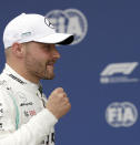 Mercedes driver Valtteri Bottas of Finland celebrates after he clocked the fastest time during the qualifying session at the Silverstone racetrack, in Silverstone, England, Saturday, July 13, 2019. The British Formula One Grand Prix will be held on Sunday. (AP Photo/Luca Bruno)