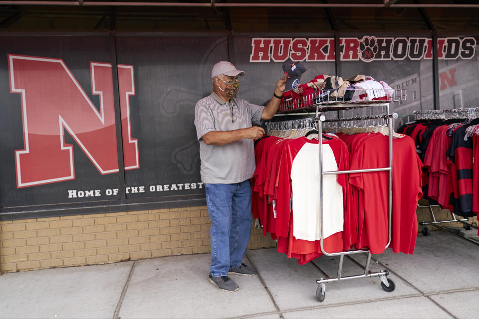 Steve Skradska shops for discounted Nebraska merchandise at the Husker Hounds store in Omaha, Neb., Wednesday, Aug. 12, 2020. The Big Ten conference announced on Tuesday, Aug. 11, 2020, they won't play football this fall because of concerns about COVID-19, becoming the first of college sports' power conferences to yield to the pandemic. (AP Photo/Nati Harnik)